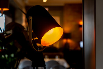 A floor lamp in the form of a lighting device from a film factory with a yellow light.