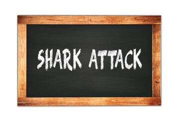 Obraz premium SHARK ATTACK text written on wooden frame school blackboard.