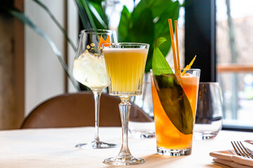 Several different cocktails are on the table in the restaurant