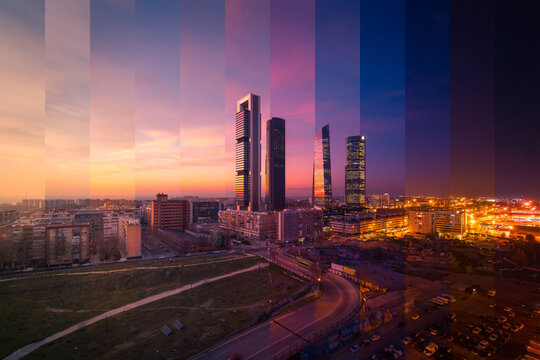 Contemporary skyscraper and multistory house exteriors against roadway and shiny light posts in Madrid at sunset