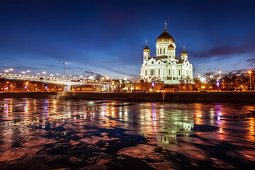 View of the Cathedral of Christ the Savior on the Prechistenskaya Embankment on the banks of the Moskva River in the winter evening. Moscow, Russia