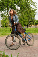 Happy young woman with bicycle