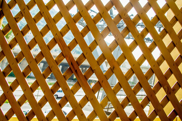 wooden lattice through which the road is visible
