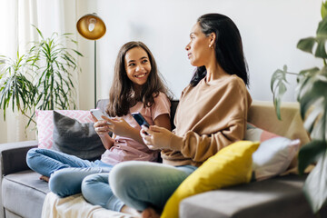 Single parenthood. Mother and daughter spending time together at home.