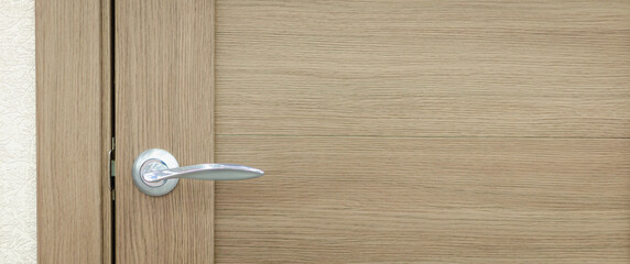 Wooden door with a beautiful handle.