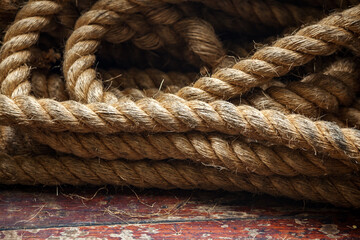 Rope on the deck of the ferry on background of the old wooden floor