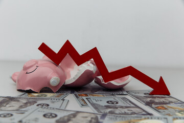 Broken piggy bank and red arrow with dollar banknotes. Investment and bankruptcy concept