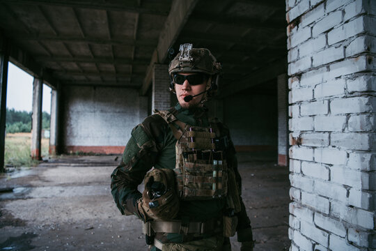 Military Man With Assault Rifle Standing Inside Building, He Is Ready For Combat