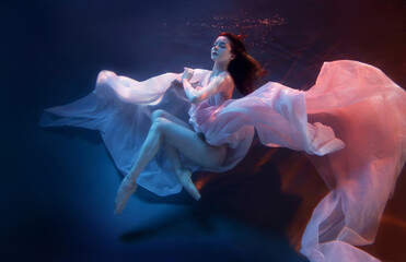 Vision. Sensual ballet dancer underwater, weightlessness and freedom. Blurred focus