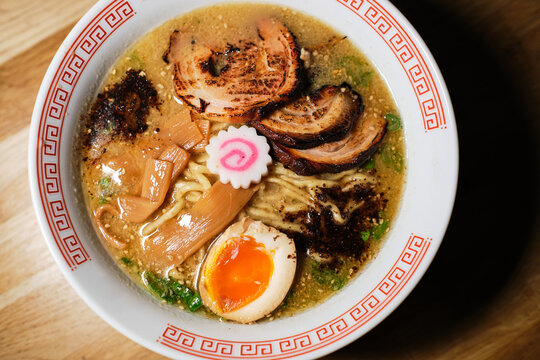 Stock photo of yummy ramen soup with boiled egg and mushrooms in japanese restaurant.
