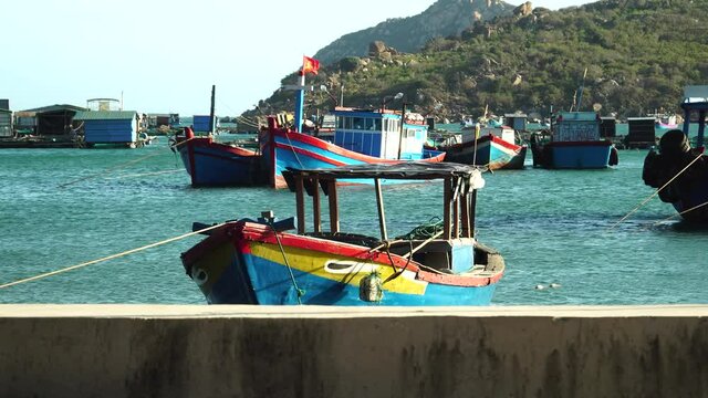 Maritime scenery of secluded Vinh Hy Bay with old fashioned blue fishing boats
