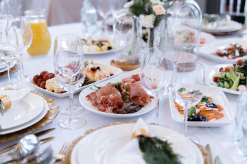Fototapeta premium Wedding table with food and drinks, beautiful dishes, luxury catering.