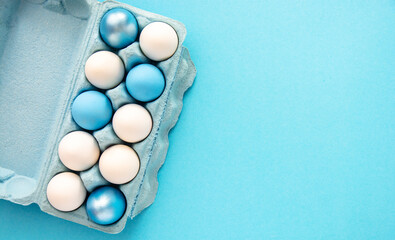 easter background with delicate blue color paint eggs on azure background