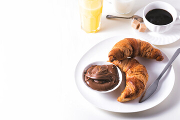 Croissant with chocolate hazelnut spread and cup of coffee