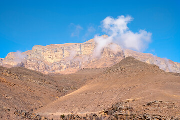 Rocky mountains bright blue sky with a small cloud
