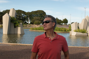 Senior Man enjoying himself at the Crystal Park (Praça dos Cristais) in Brasilia, Brazil