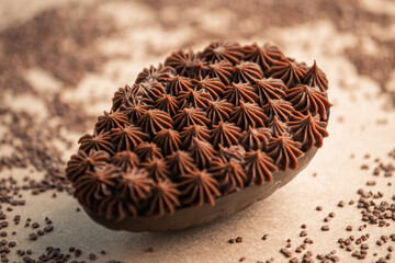 Stuffed chocolate easter egg with sprinkles around on a table. Gourmet.