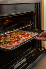Putting an artisan pizza in the oven