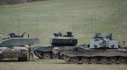 Fototapeta premium the crews from british army Challenger II 2 FV4034 main battle tanks take a well earned break from a military exercise, Wiltshire