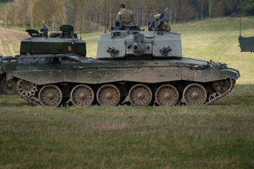 Fototapeta premium the crew of four from a british army Challenger II 2 FV4034 main battle tank take a well earned break from a military exercise, Wiltshire