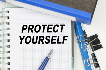 Among the documents, folders, a notebook with the inscription - PROTECT YOURSELF