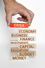 Businessman hand sets on a tower with business words red wooden block with the inscription - ERISA