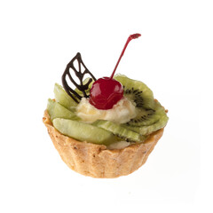 Dessert, cake with kiwi and cherries, on a white plate isolated