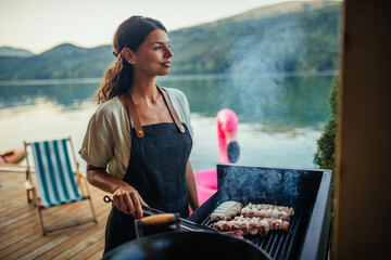 Female is barbecuing in the great outdoors