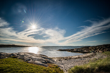 Wide angle photo of a sand beach and cliffs in summer.
