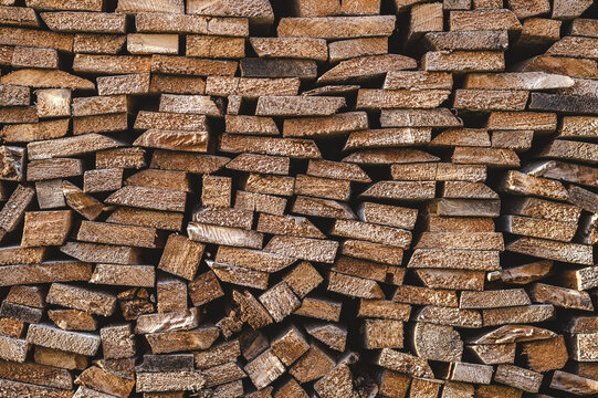 Stacked timber chopped wood board close-up, firewood background pattern 