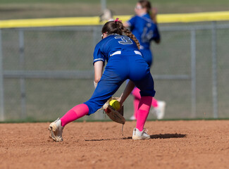 Girls in action playing in a softball game