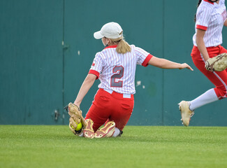 Girls in action playing in a softball game
