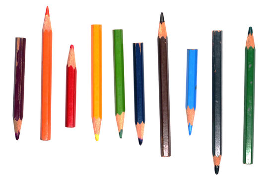Old color pencils in different lengths on white background