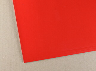 Red paper on cardboard surface background and texture