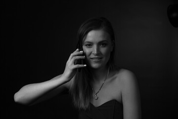 black and white portrait of an adult woman in a studio on a black background.