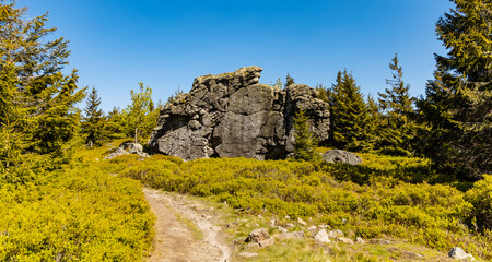 Giant rocks next to mountain trail in Jizera mountains