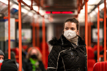 woman in public transport with a respirator on her face. coronavirus epidemic