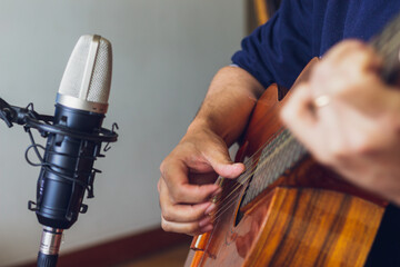 Close-up of musician playing and recording guitar