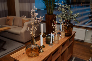 interior items in the restaurant. console table. vase of flowers, candles, magazine