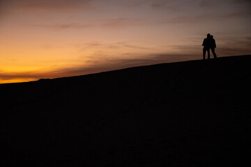 silhouette of a person on the top of mountain