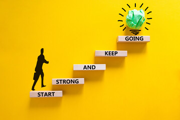 Start strong and keep going symbol. Concept words 'Start strong and keep going' on wooden blocks on a beautiful yellow background. Businessman icon. Business, motivational and start strong concept. - obrazy, fototapety, plakaty