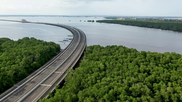 South of Mandara Toll Road and Gerbang Tol in Bali Indonesia above the Gulf of Benoa, Aerial dolly left shot