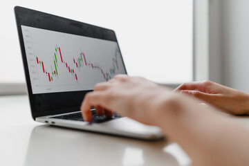Woman working at home office hand on keyboard close up