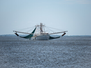fishing boat sailing along the coast