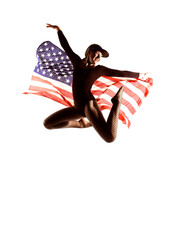 A patriotic female dancer is seen in front
of a white background. She proudly waves the 
American...