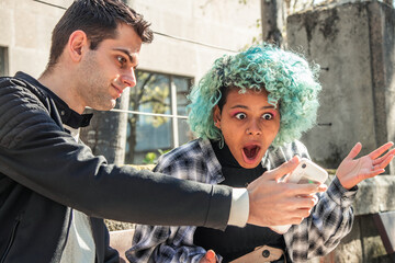 couple looking at mobile phone checking with surprise