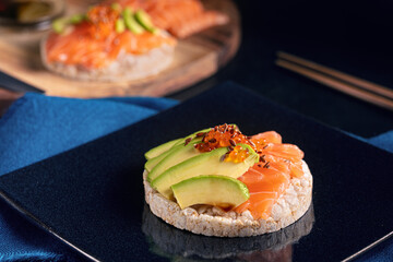 Puffed rice spread with raw salmon and avocado