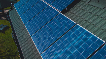 Photovoltaic sun power plant on the top of domestic house. Detail of solar panels for electricity...