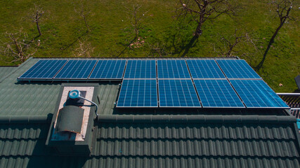 Photovoltaic sun power plant on the top of domestic house. Detail of solar panels for electricity...