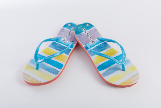 Aeropostale colorful beach sandals on white background.